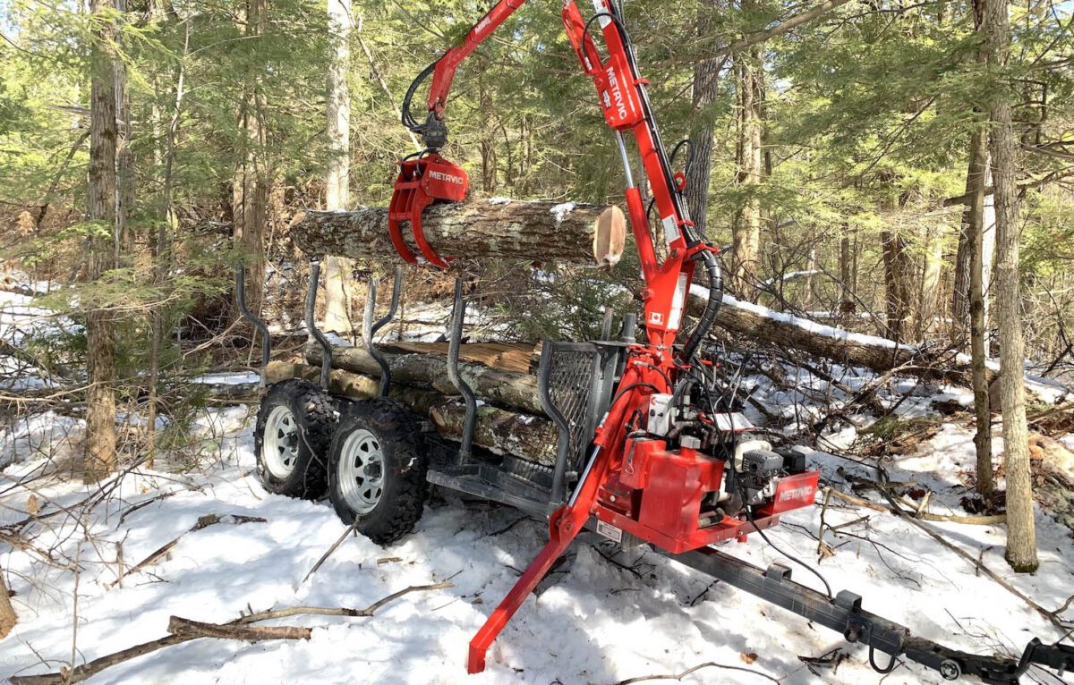 John McNerney's log forwarder with logs on it in the forest.