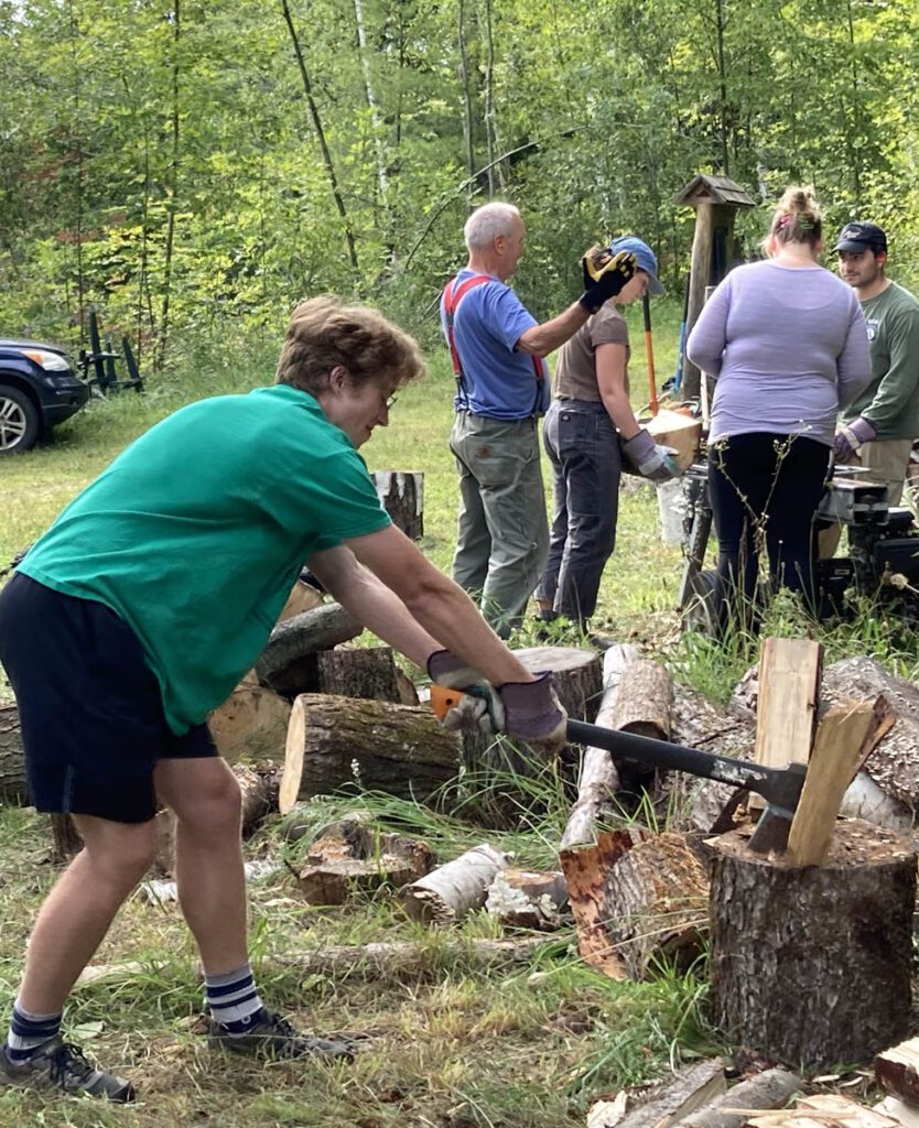 person splitting firewood with an axe.
